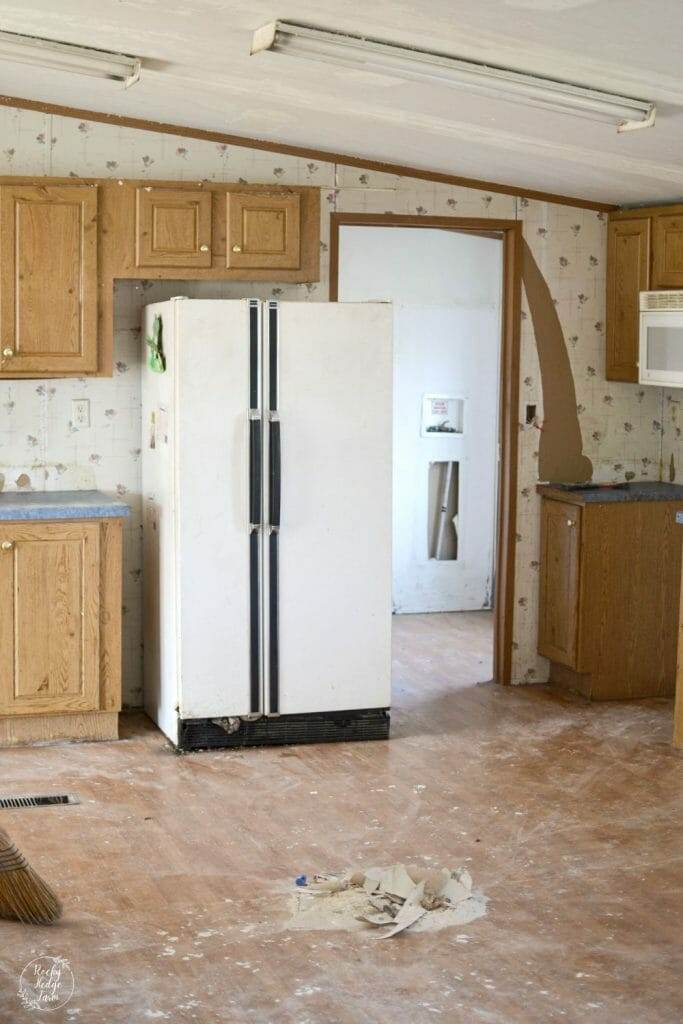 A small pantry in a mobile home that has wire shelving and floral wallpaper