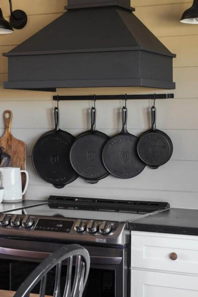 storing cast iron by hanging them on the wall with a rack