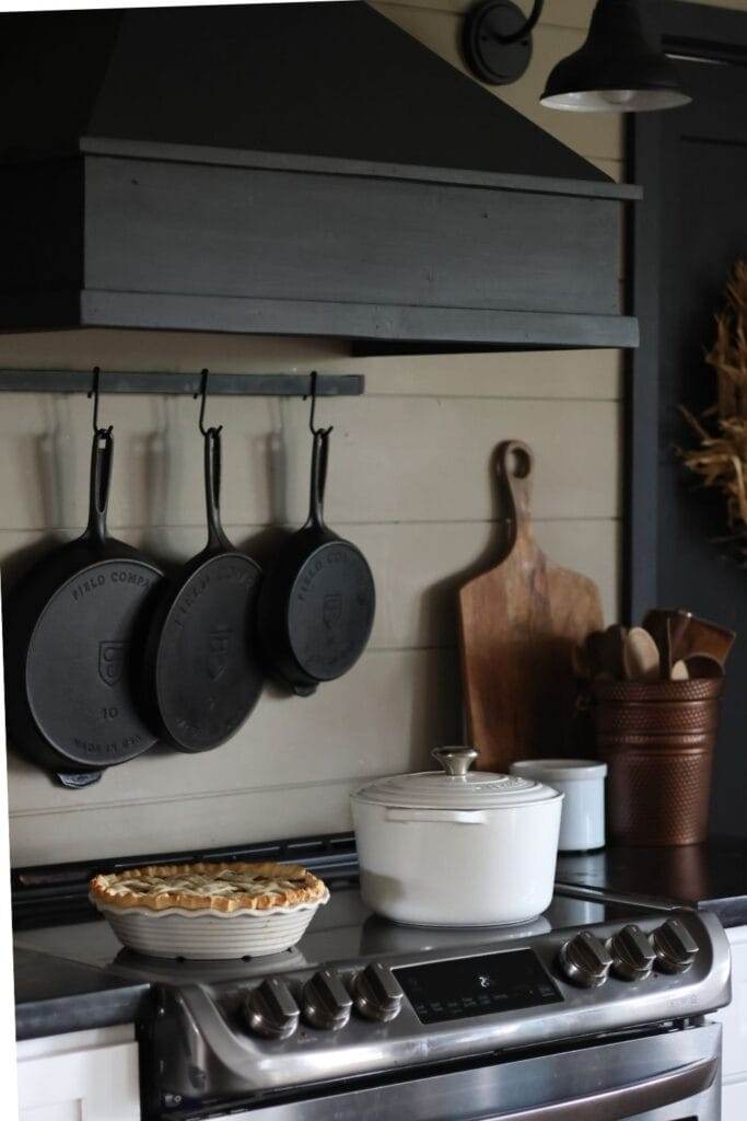 hanging cast iron skillets on a wall.