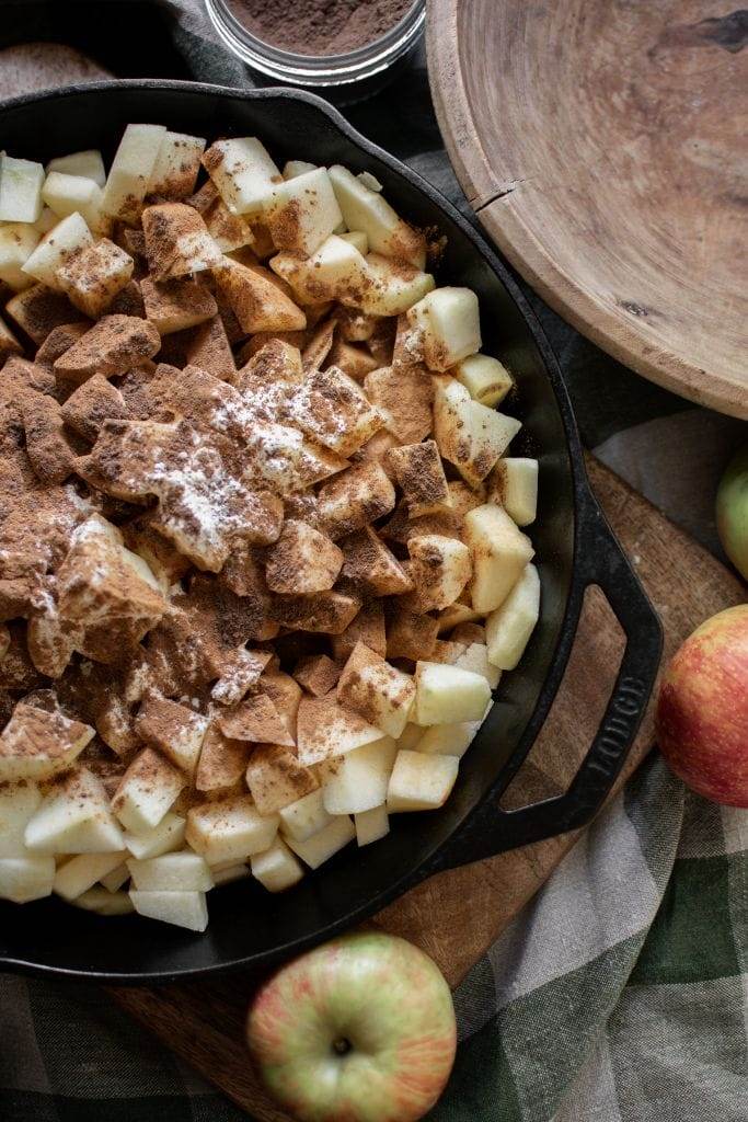 apples with seasoning in a cast iron skillet