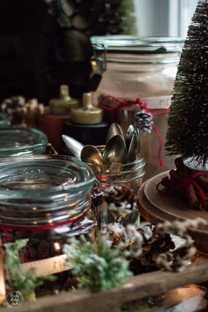 Spoons in a jar on a tray decorated for a hot chocolate bar