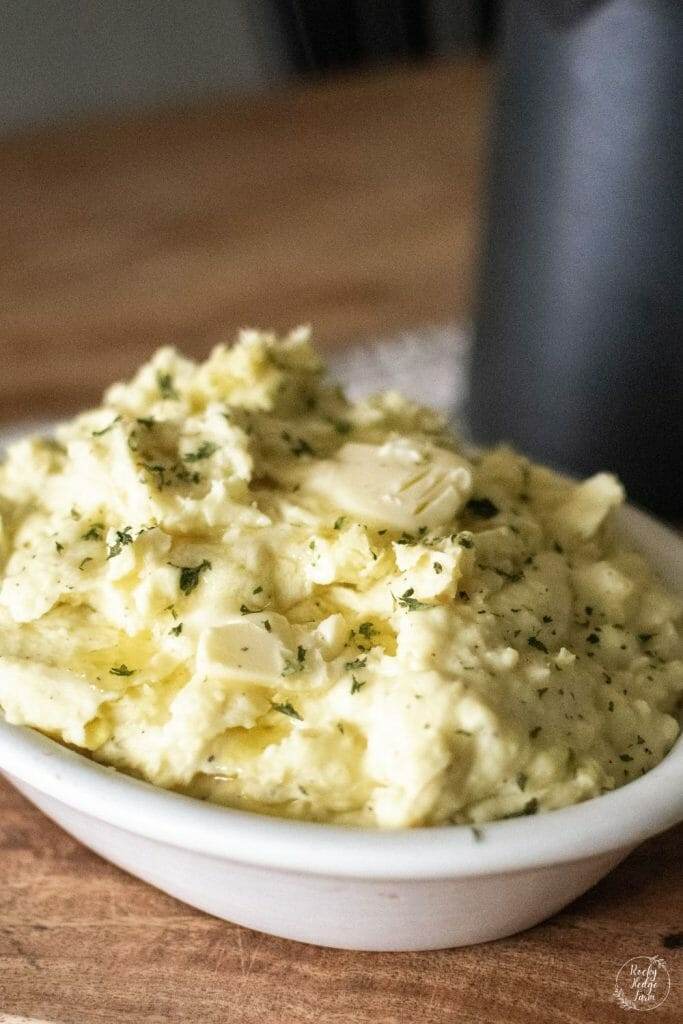 A bowl full of loaded mashed potatoes