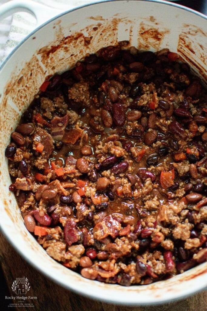 White Dutch Oven Loaded with Flavorful Cowboy Beans