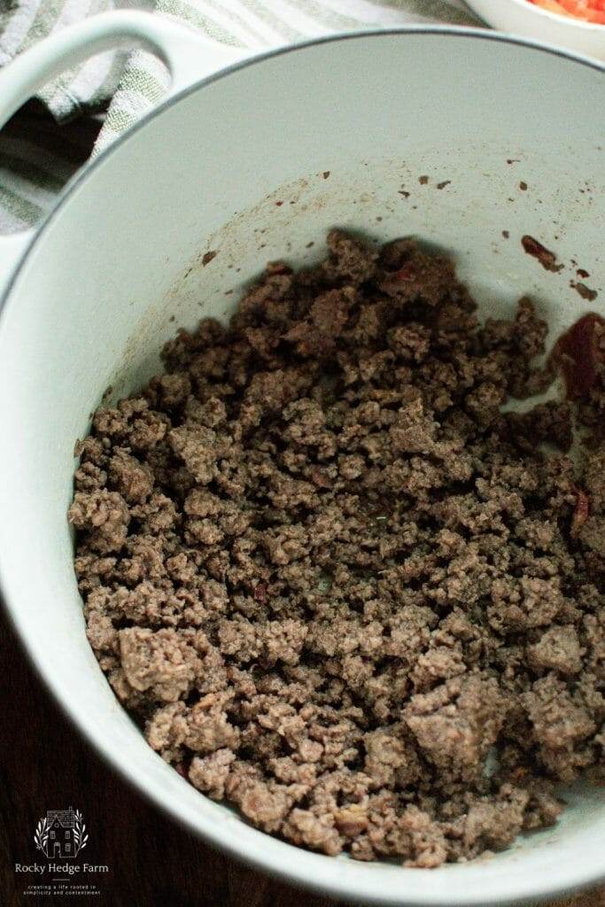 Cooking hamburger in a white dutch oven