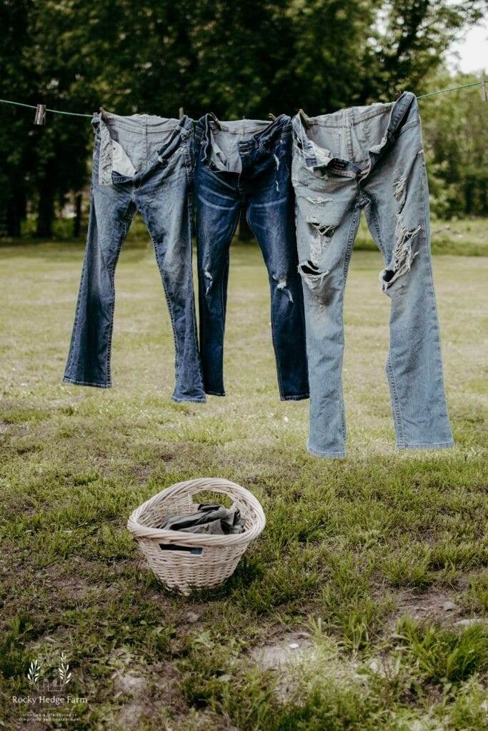 three pairs of jeans hanging on the clothesline