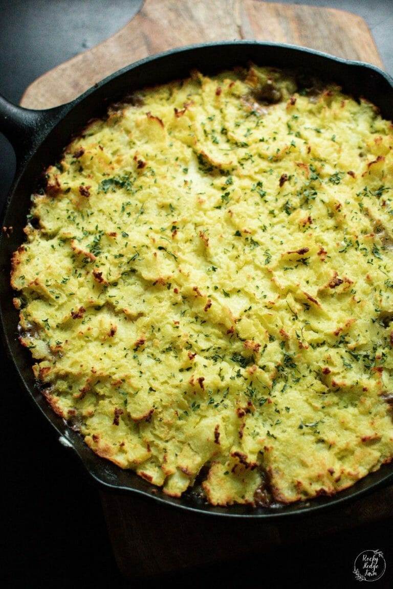 A delicious and hearty Shepherd's Pie in a cast iron skillet, topped with creamy mashed potatoes.