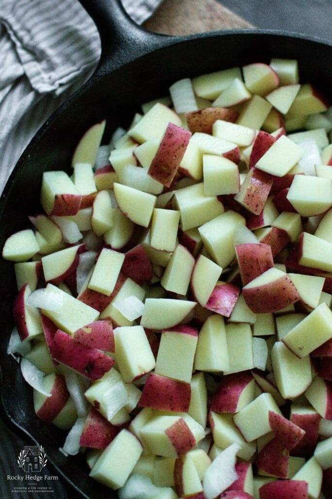 diced potatoes in a cast iron skillet