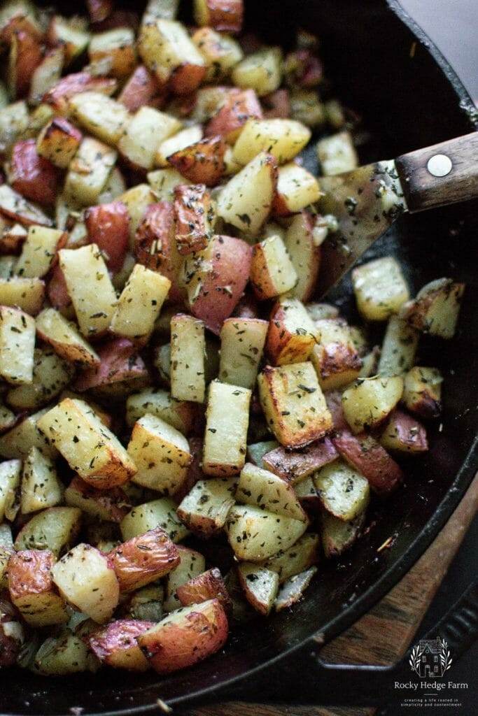 The cast iron skillet filled with golden-brown potatoes and onions fresh out of the oven