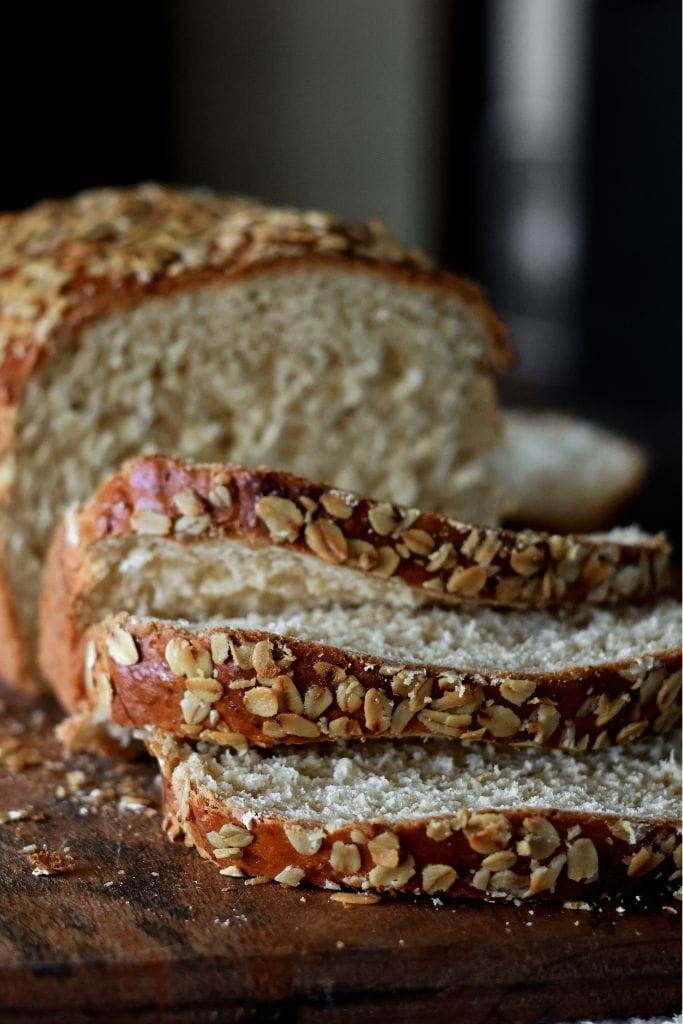 a loaf of oatmeal bread with slices cut