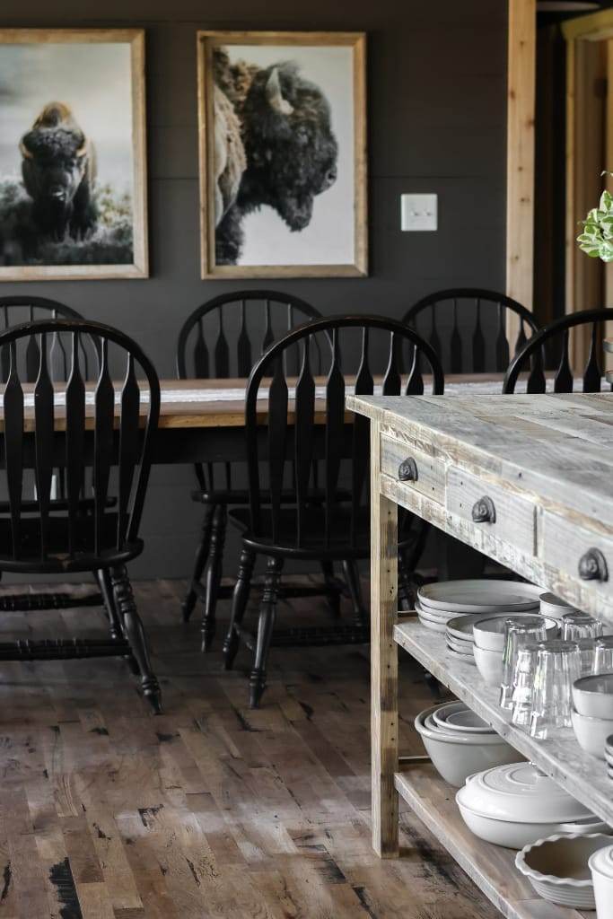 Warm and inviting kitchen featuring a reclaimed wood island with a breakfast bar for two, complemented by hidden storage space ion the shelves and in the drawers.