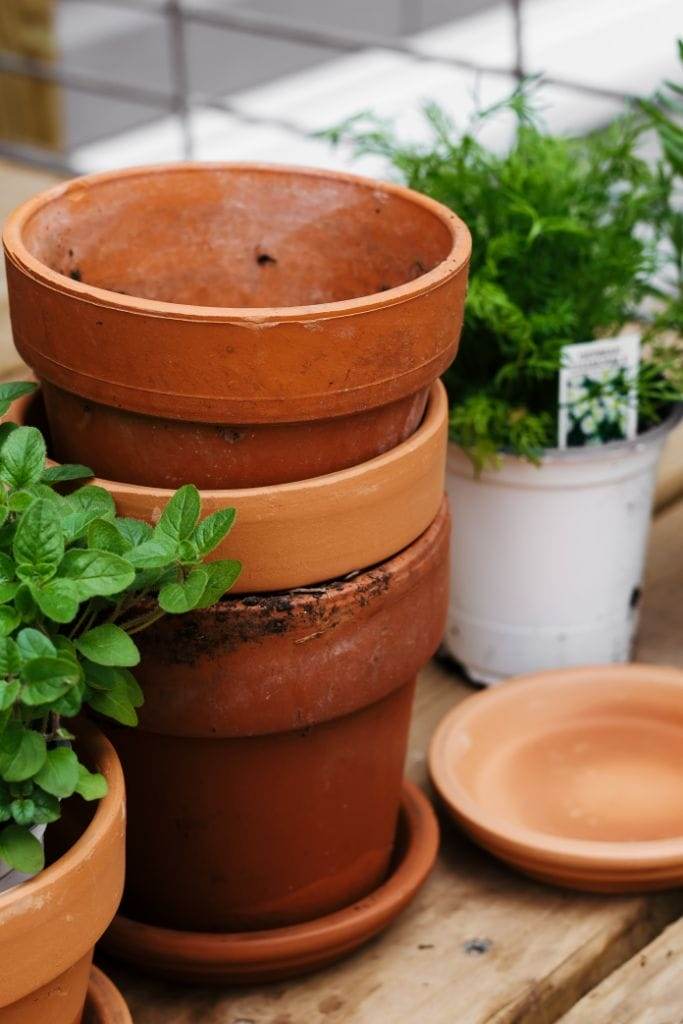 A stack of terra cotta pots that will be filled with herbs.