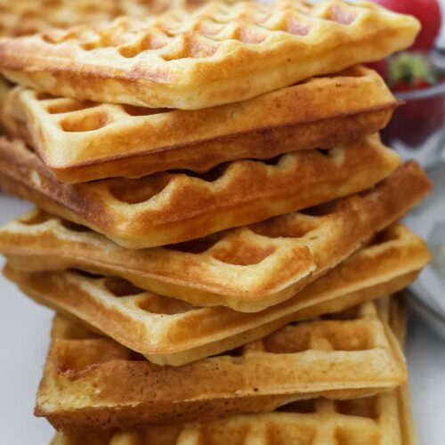 a large stack of homemade waffles