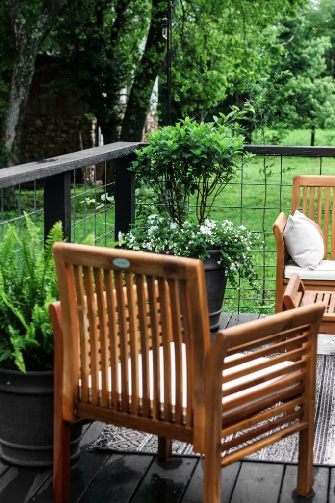 Outdoor rug, string lights, and planters add personality to a manufactured home porch.