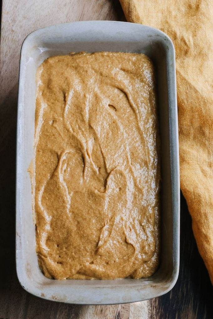 pumpkin bread batter in a loaf pan