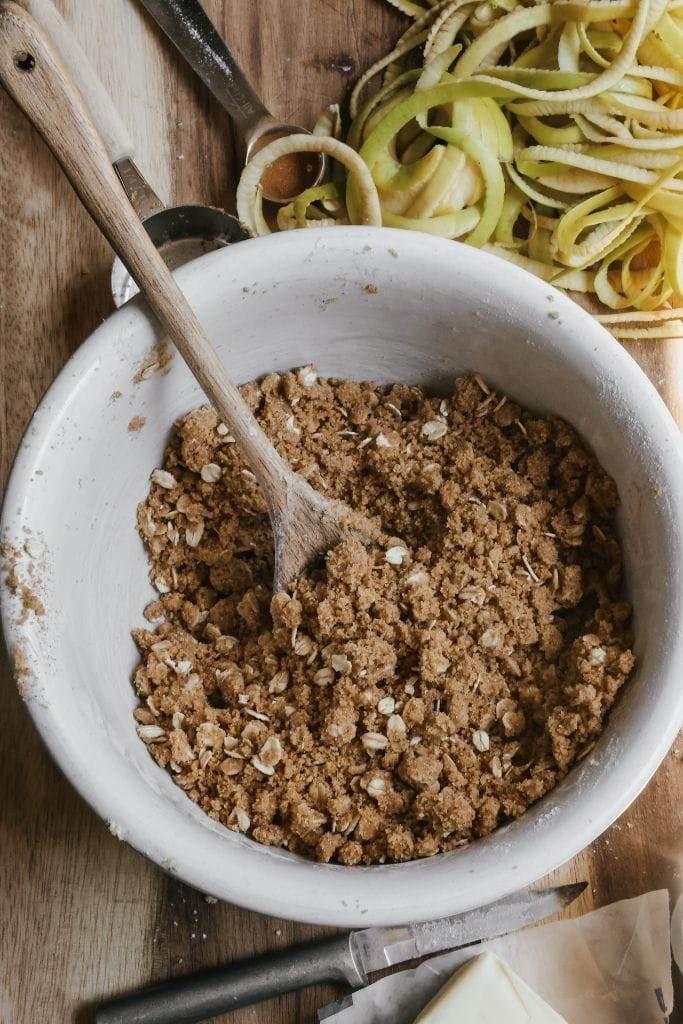 a bowl of oatmeal streusel topping for apple crisp bars