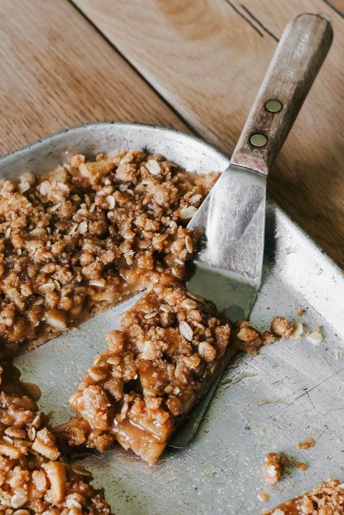 a piece of apple crisp bars on a spatula