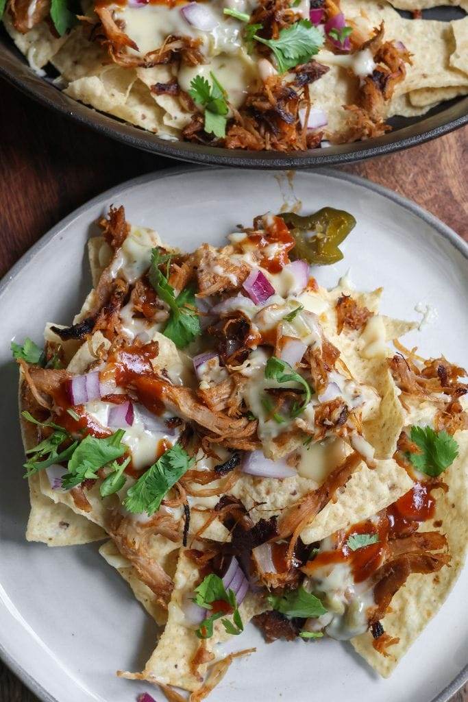 a plate with bbq nachos on it