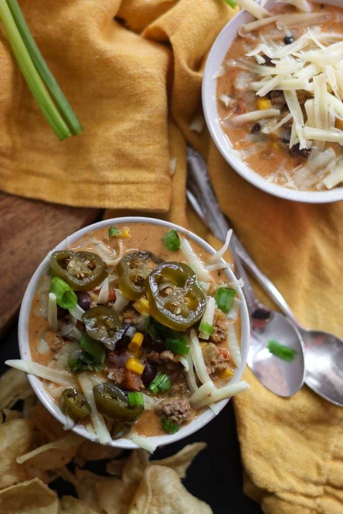 two bowls of creamy taco soup with toppings