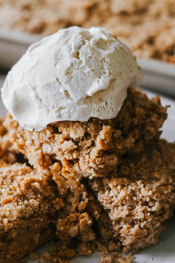 a bowl of pumpkin crisp topped with vanilla ice cream