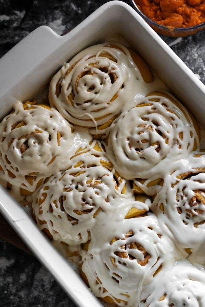 Freshly baked cinnamon rolls topped with a generous layer of cinnamon maple cream cheese frosting