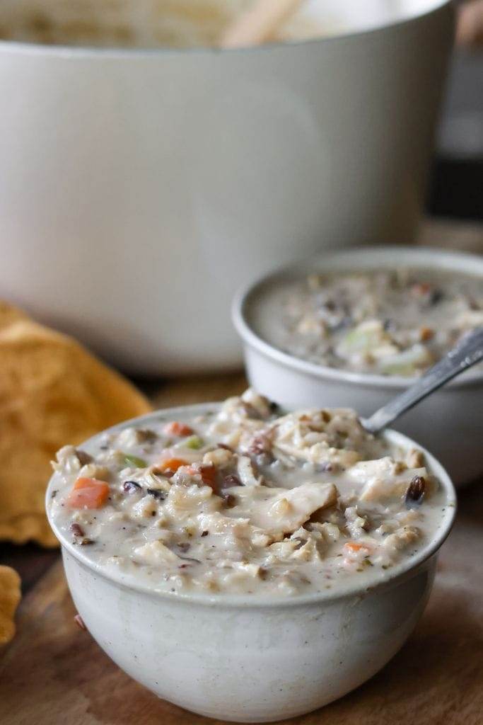 Warm bowls of creamy chicken and wild rice soup, filled with tender shredded chicken, wild rice, and vegetables