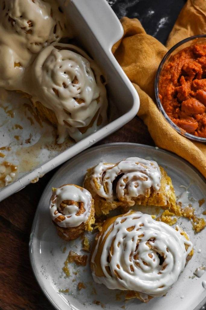 pumpkin spice cinnamon rolls on a plate