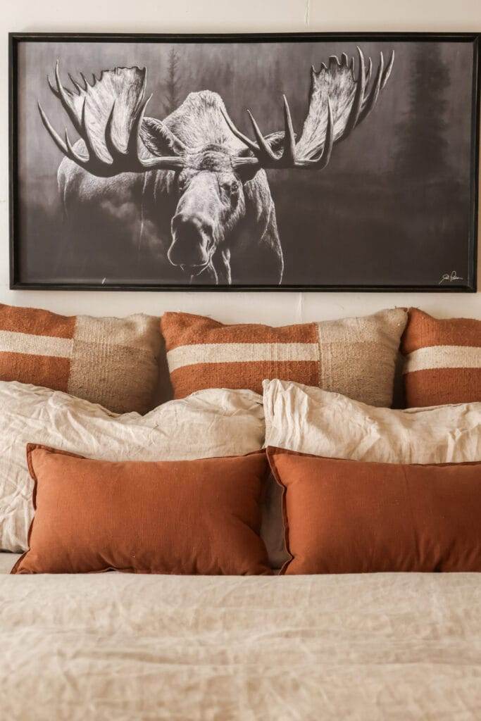 rust colored pillows with natural linen bedding