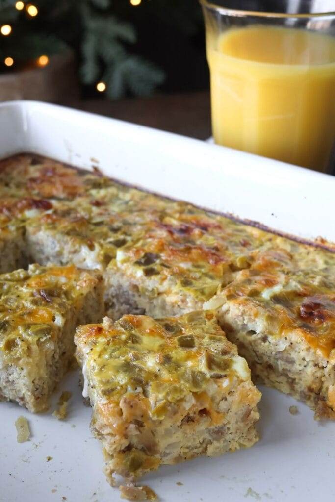 A close-up of a perfectly baked Sausage Hashbrown Breakfast Casserole with a golden, cheesy top, sliced and ready to serve.