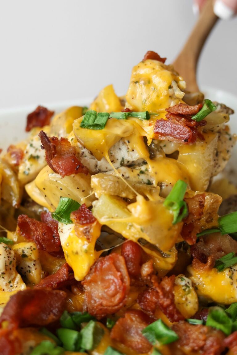 A hearty serving of Chicken Potato Casserole featuring crispy bacon, tender chicken, and melted cheddar cheese, perfect for a family dinner.