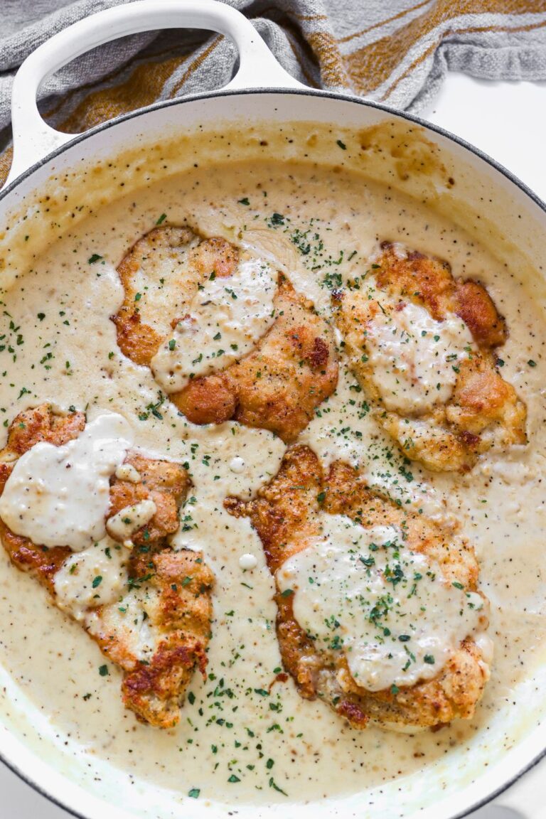 an overhead view of a pan full of creamy garlic chicken