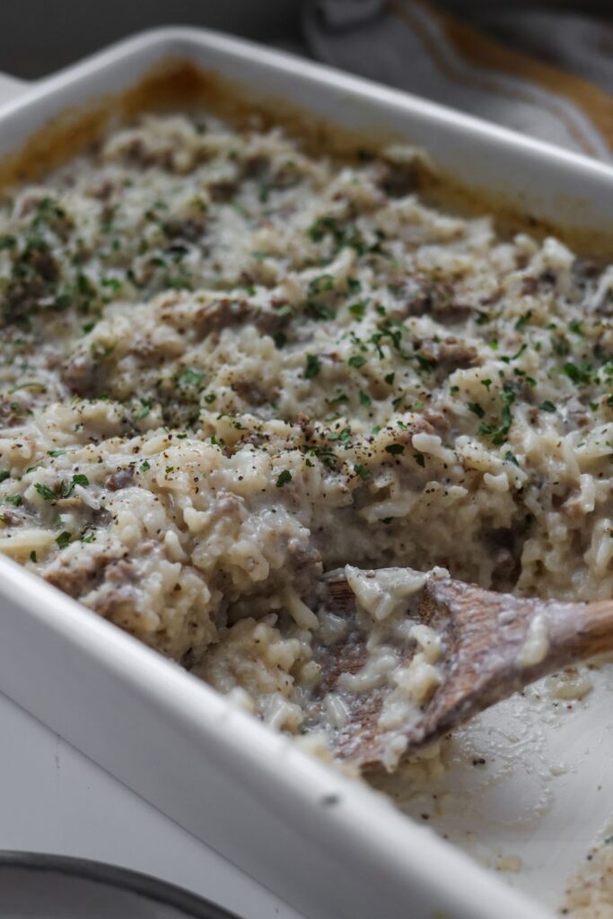 Hamburger rice casserole fresh from the oven with a sprinkle of parsley.