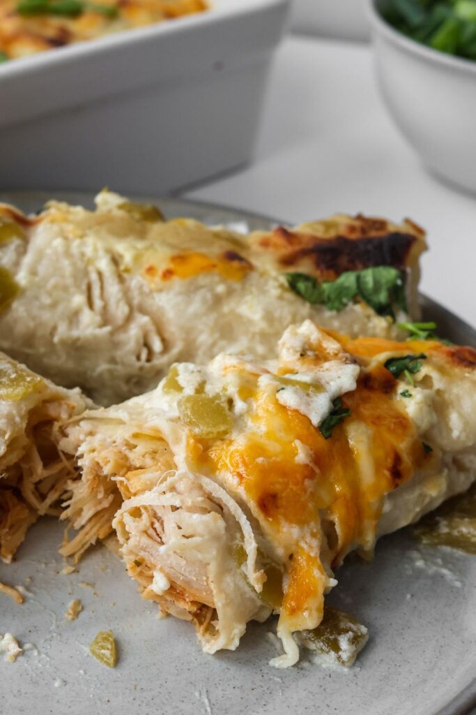 two creamy chicken enchiladas with sour cream sauce