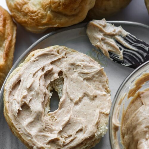 An overhead shot of a bagel covered with brown sugar cinnamon cream cheese.