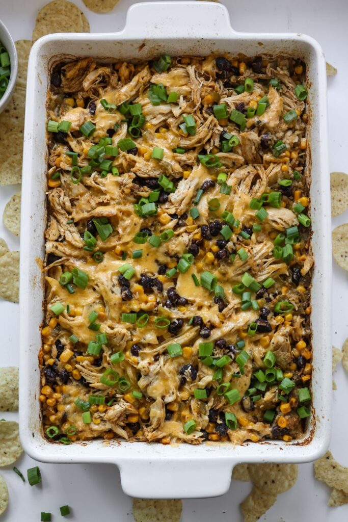 Delicious Chicken Burrito Casserole baked in a 9x13 pan, topped with melted cheddar cheese and ready to serve.