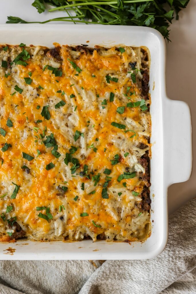 A whole hamburger hashbrown casserole in a 9x13 baking dish.