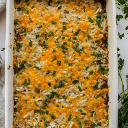 Baked hamburger hashbrown casserole in a dish.