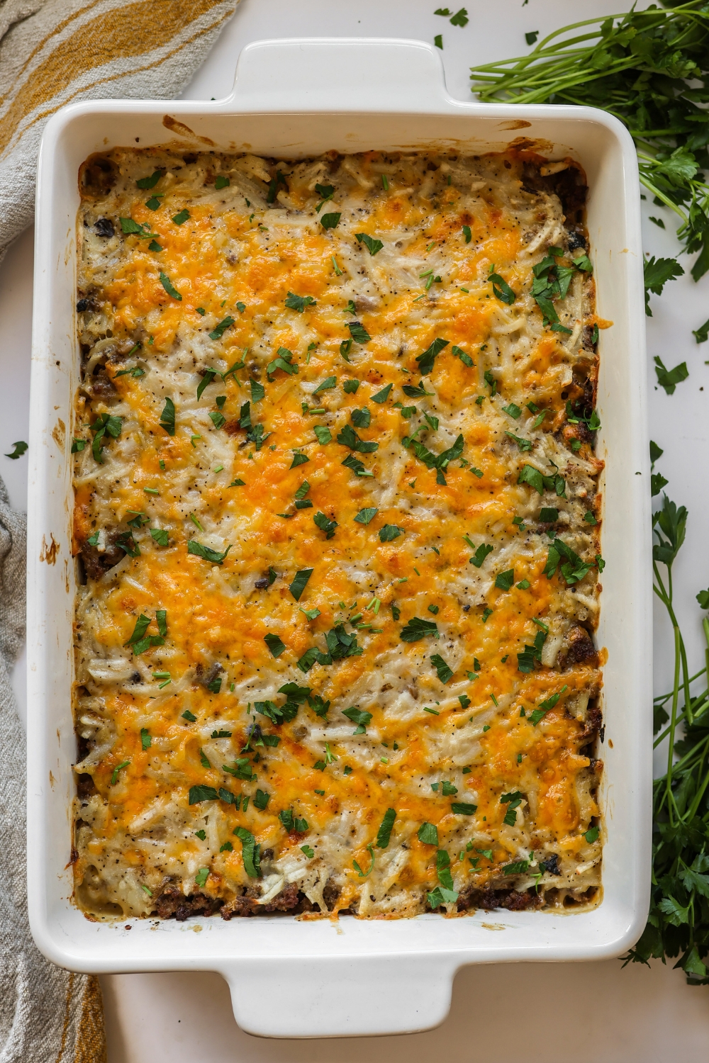 Baked hamburger hashbrown casserole in a dish.